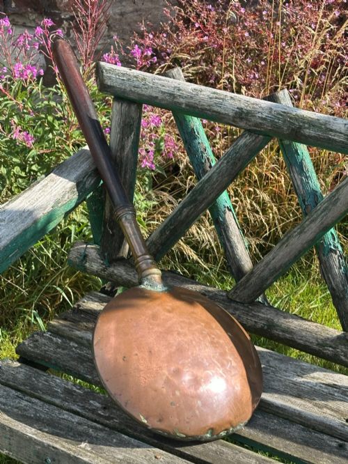 fig 1. A circular Georgian copper moon flask with a threaded top loop, displayed alongside a separate turned dark oak handle.