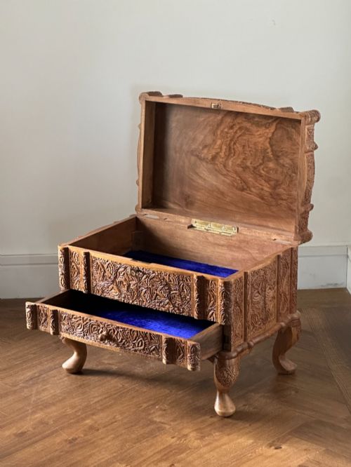 fig 1. An intricately carved Anglo-Indian wooden jewellery casket featuring a sarcophagus-shaped lid and raised cabriole legs.