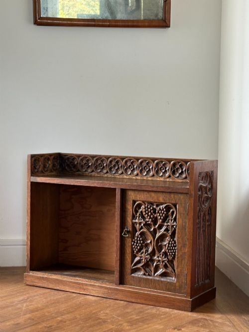 An Arts and Crafts Carved Oak Table Cabinet in the Manner of Arthur Simpson of Kendal (1857-1922)