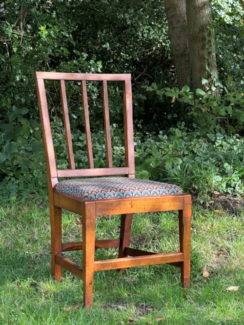 fig 1. A George III solid birch side chair featuring a vertical reeded slat back, patterned geometric fabric seat, and square tapered legs with stretchers.
