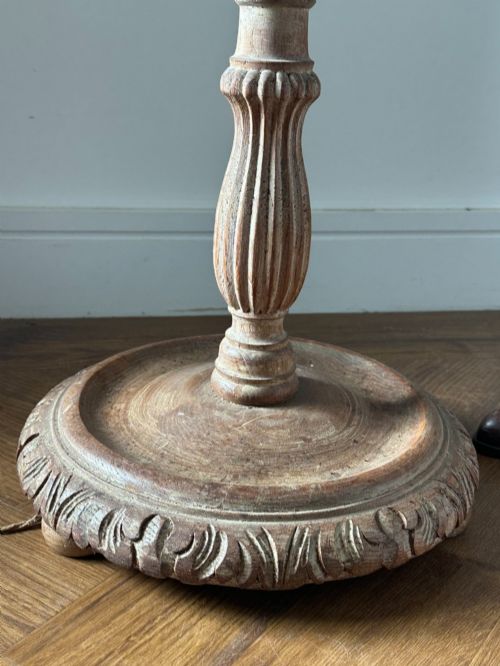 fig 1. A carved limed oak floor lamp from the 1920s featuring a fluted column, leaf motifs, and a circular base.