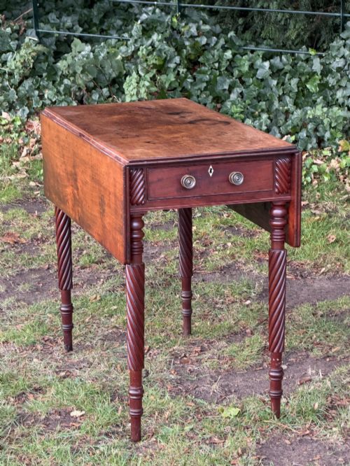 fig 1. A George IV mahogany drop-leaf table featuring spiral turned legs, a single drawer with twin pull knobs, and two folding side leaves.