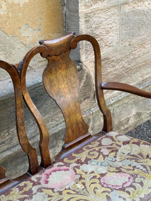 fig 1. A late nineteenth-century George II style double chair-back settee in warm brown walnut and burr walnut with shepherd crook arms and an upholstered seat.