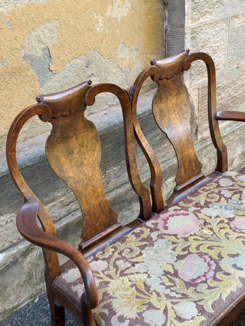 fig 2. A late nineteenth-century George II style double chair-back settee in warm brown walnut and burr walnut with shepherd crook arms and an upholstered seat.