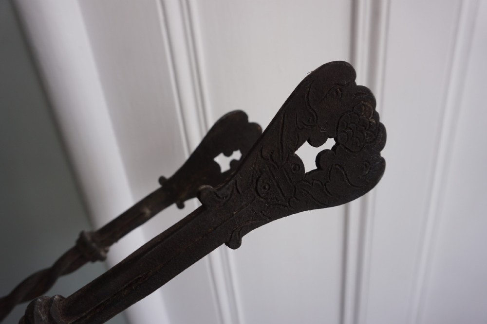 An interesting pair of wrought iron fire tongs, probably late 17th or early 18th century View V