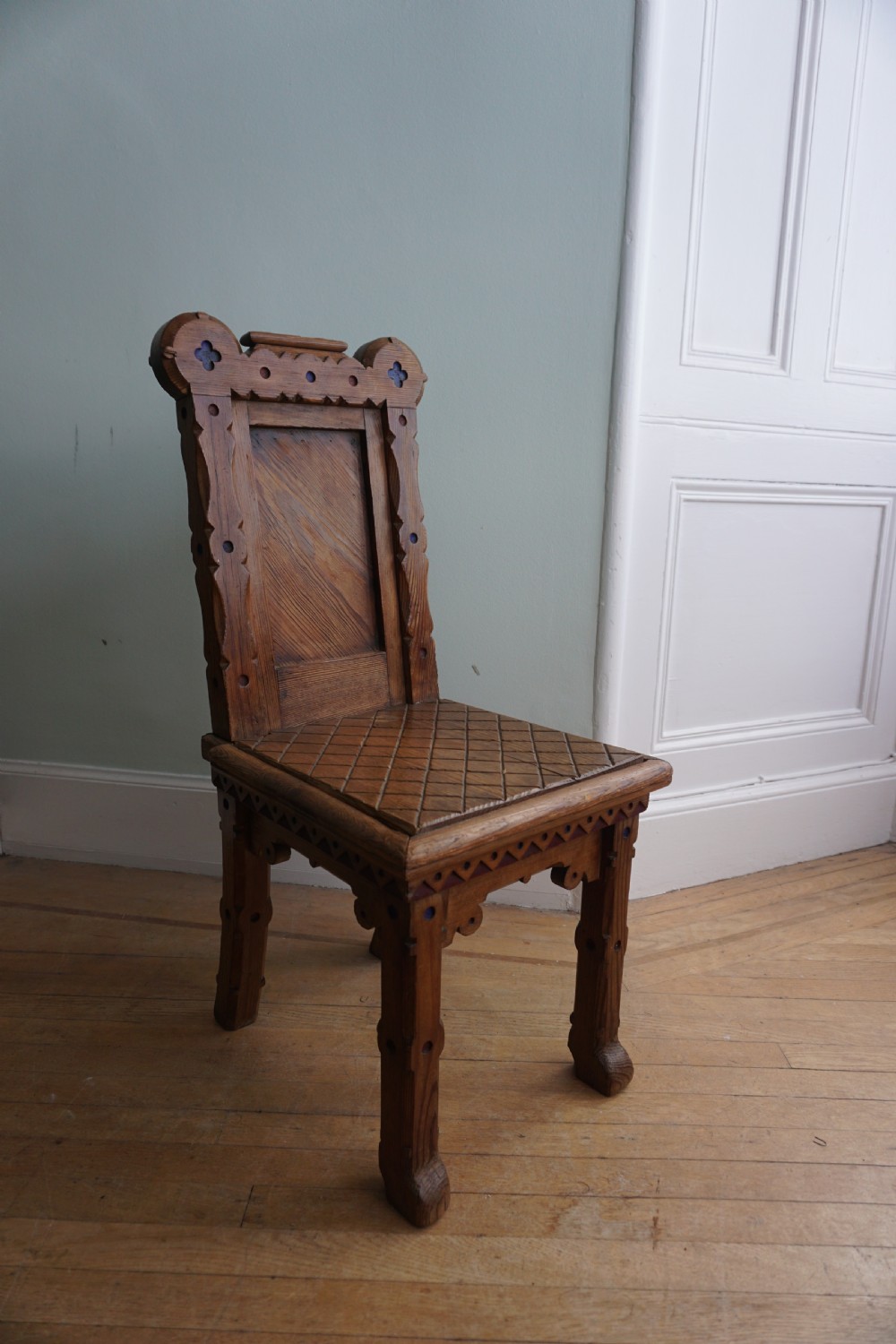 A pitch pine and coloured enamel Gothic Revival hall chair in the manner of Bruce Talbert, 1860s