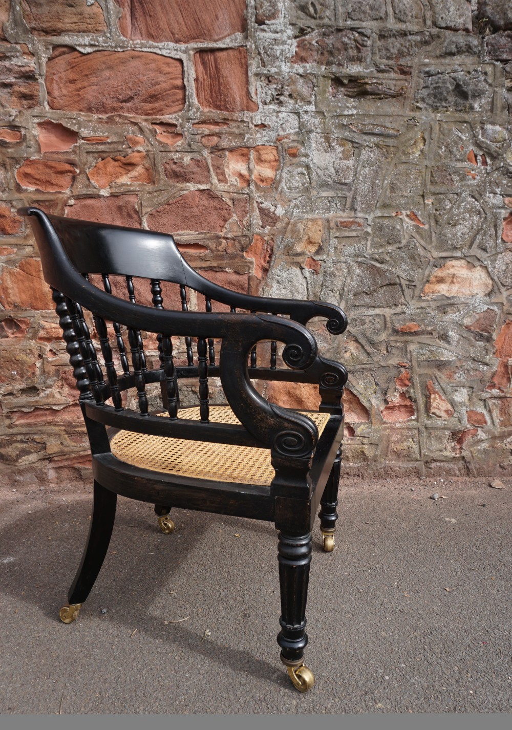 A Scottish George IV ebonised library bergere armchair View III