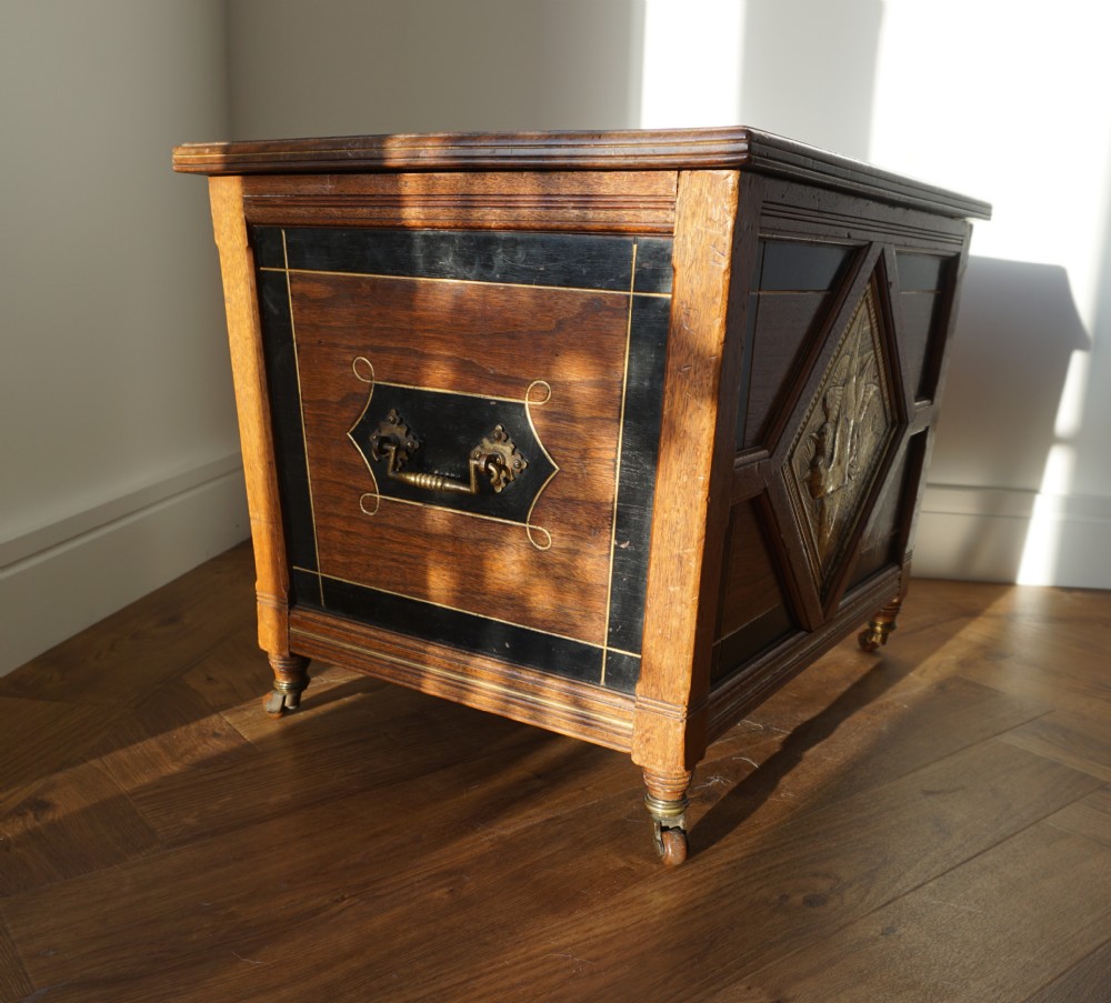 An Aesthetic Movement walnut sarcopagus-shaped coal box or cellaret by Holland & Sons or similar, 1880s. View III