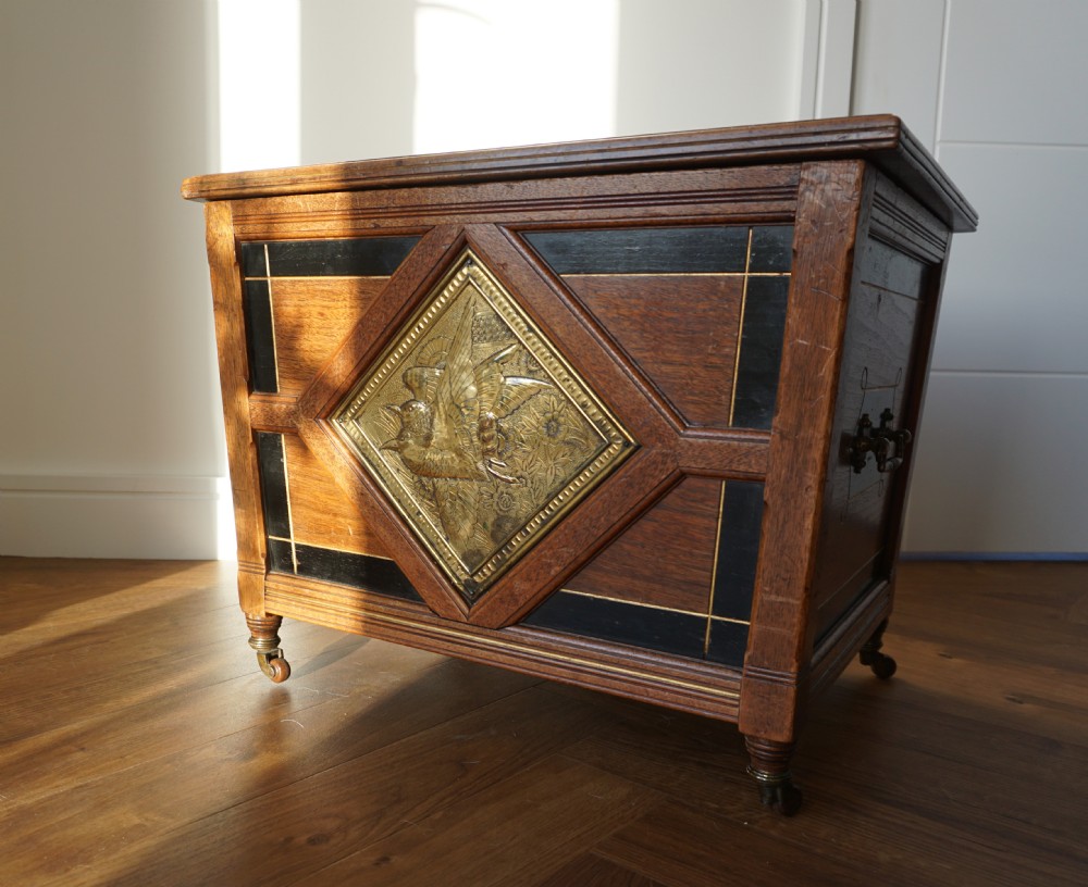 An Aesthetic Movement walnut sarcopagus-shaped coal box or cellaret by Holland & Sons or similar, 1880s. View IV