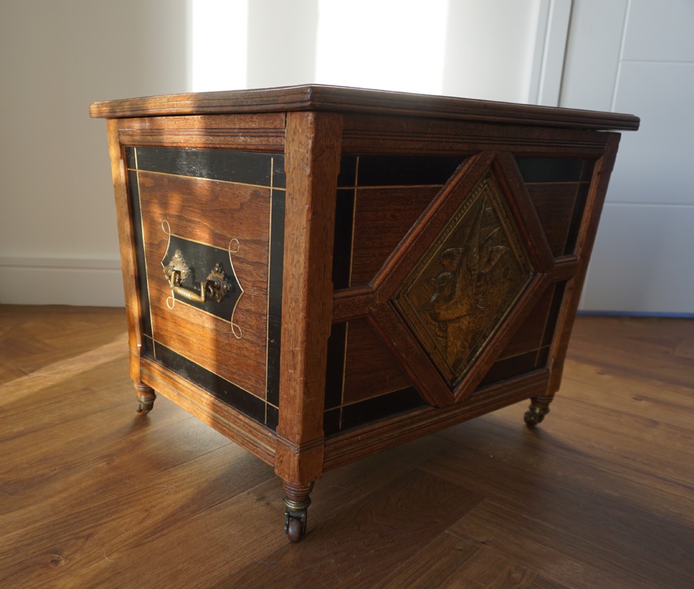 An Aesthetic Movement walnut sarcopagus-shaped coal box or cellaret by Holland & Sons or similar, 1880s. View V