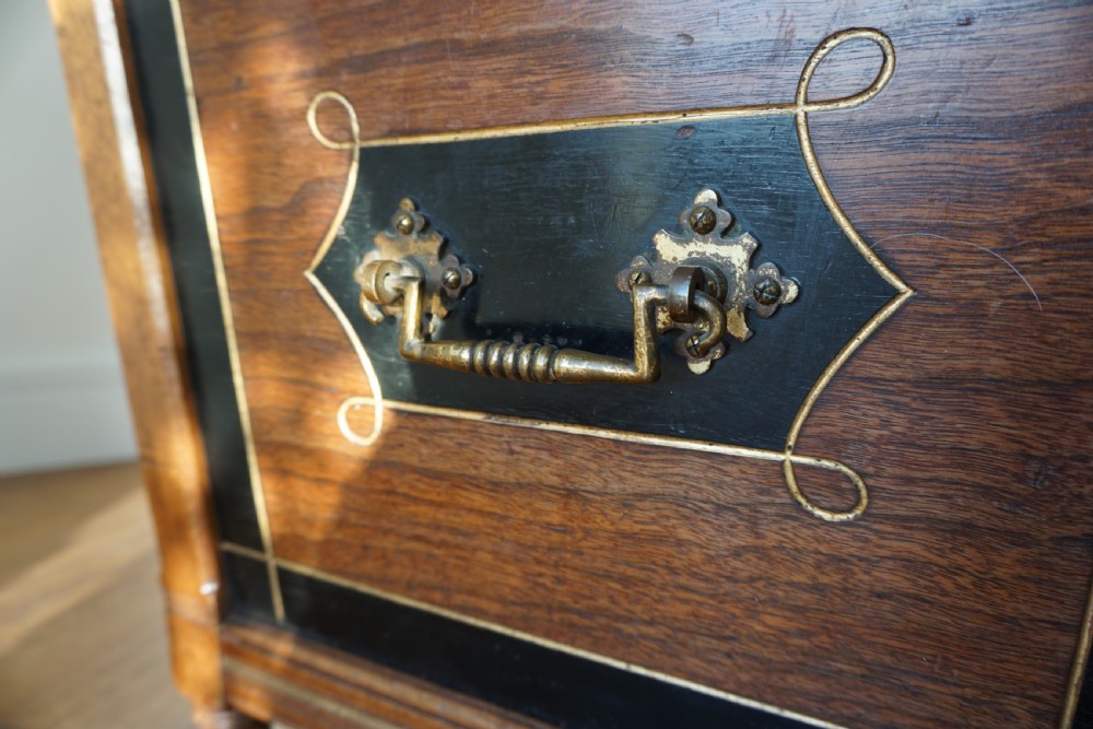 An Aesthetic Movement walnut sarcopagus-shaped coal box or cellaret by Holland & Sons or similar, 1880s. View VII