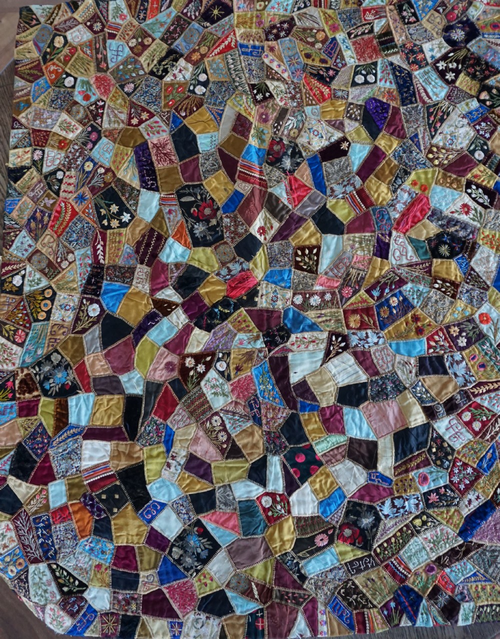 A fine Victorian Aesthetic 'crazy' patchwork parlour panel, comprising intricately hand-worked silk and velvet sections.