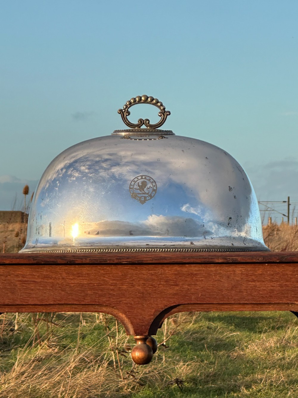 A large silver plated cloche or meat cover engraved with the crest of the Macfie clan and dating to c.1870