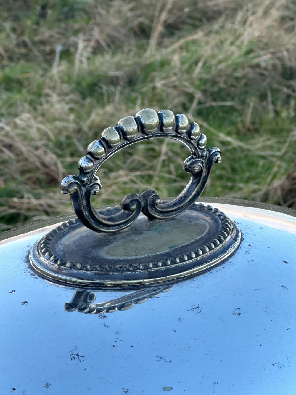 A large silver plated cloche or meat cover engraved with the crest of the Macfie clan and dating to c.1870 View V