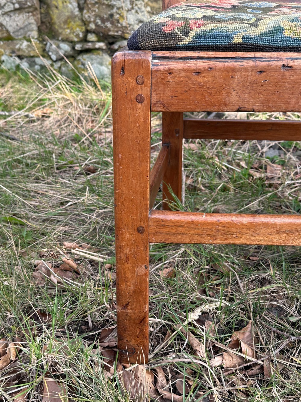 A George III walnut side chair featuring a carved pierced splat back and a floral needlepoint upholstered drop-in seat. View III