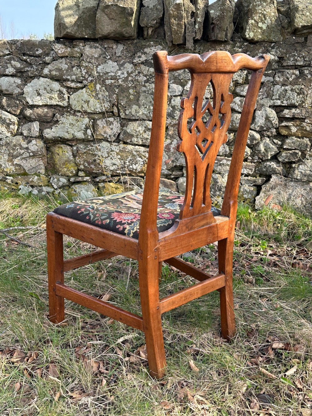 A George III walnut side chair featuring a carved pierced splat back and a floral needlepoint upholstered drop-in seat. View IV