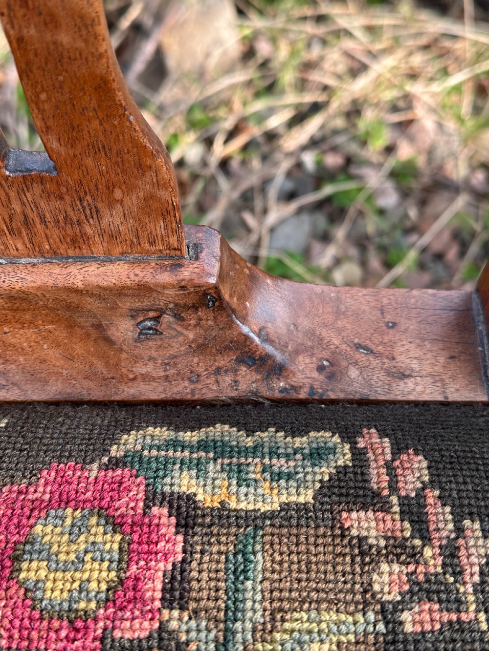 A George III walnut side chair featuring a carved pierced splat back and a floral needlepoint upholstered drop-in seat. View V