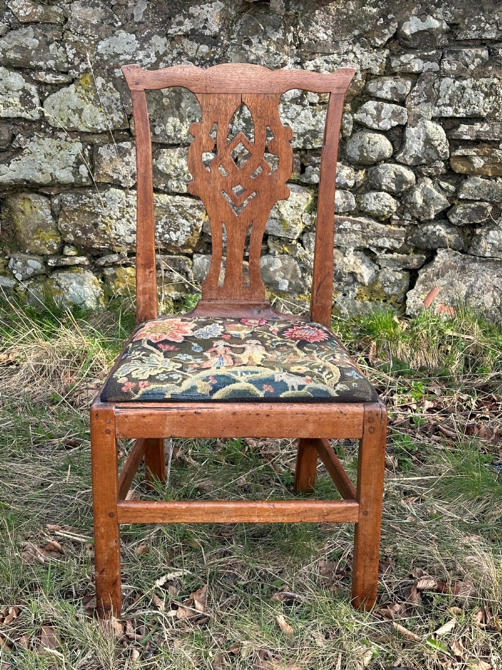A George III walnut side chair featuring a carved pierced splat back and a floral needlepoint upholstered drop-in seat. View VII