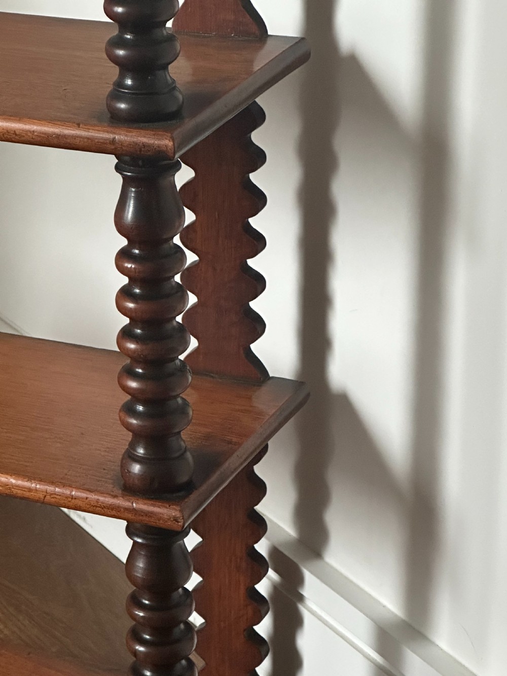 A mid-19th century mahogany set of shelves with bobbin supports View III