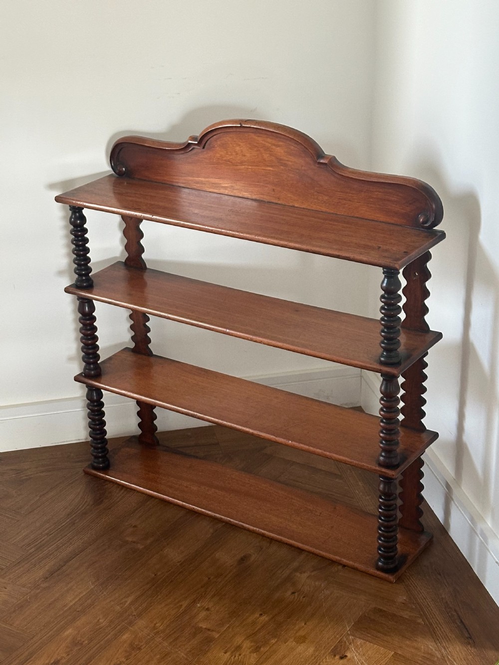A mid-19th century mahogany set of shelves with bobbin supports View V
