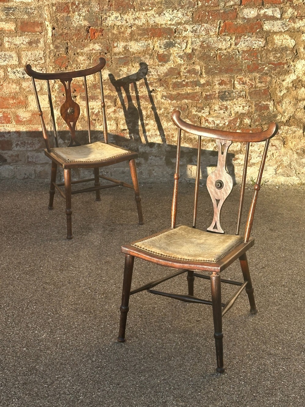 A pair of Art Furniture mahogany side chairs in the manner of/ and quite possibly by the firm J S Henry, London and Glasgow c.1895