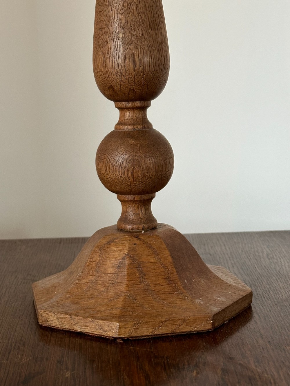A pair of Arts and Crafts carved and turned oak candlesticks in the style of Sir Edwin Lutyens View II