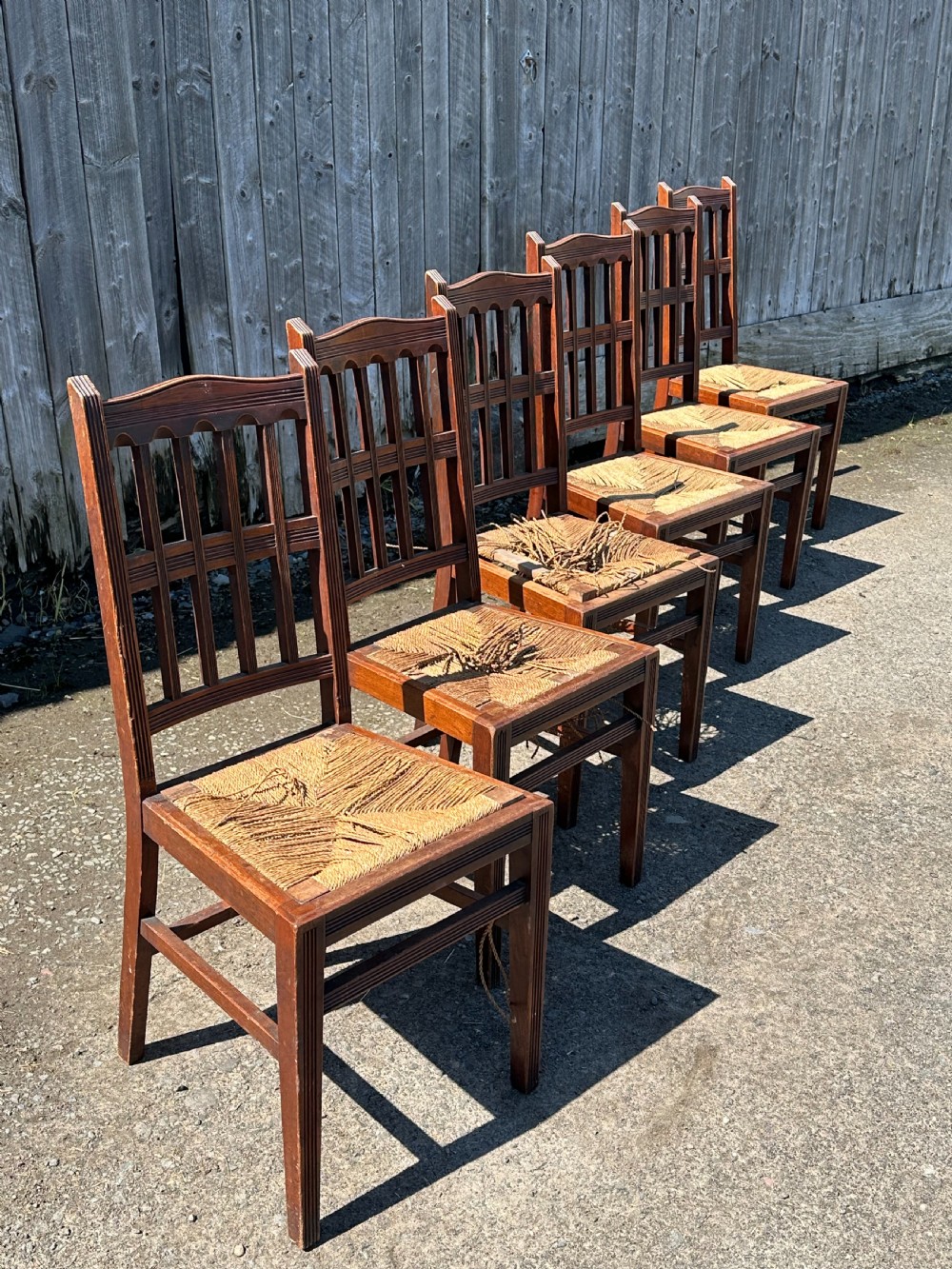 A set of eight Arts and Crafts walnut dining chairs in the manner of Philip Webb, 1860's View III