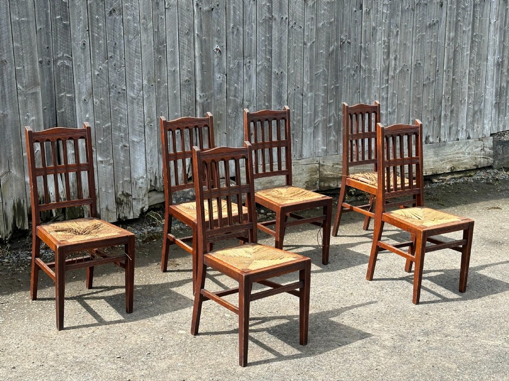 A set of eight Arts and Crafts walnut dining chairs in the manner of Philip Webb, 1860's View II