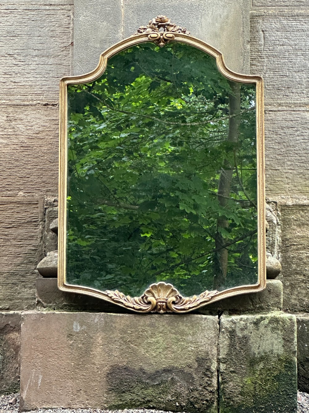 A chic 1920's cartouche-shaped wall mirror, probably by Whytock and Reid 