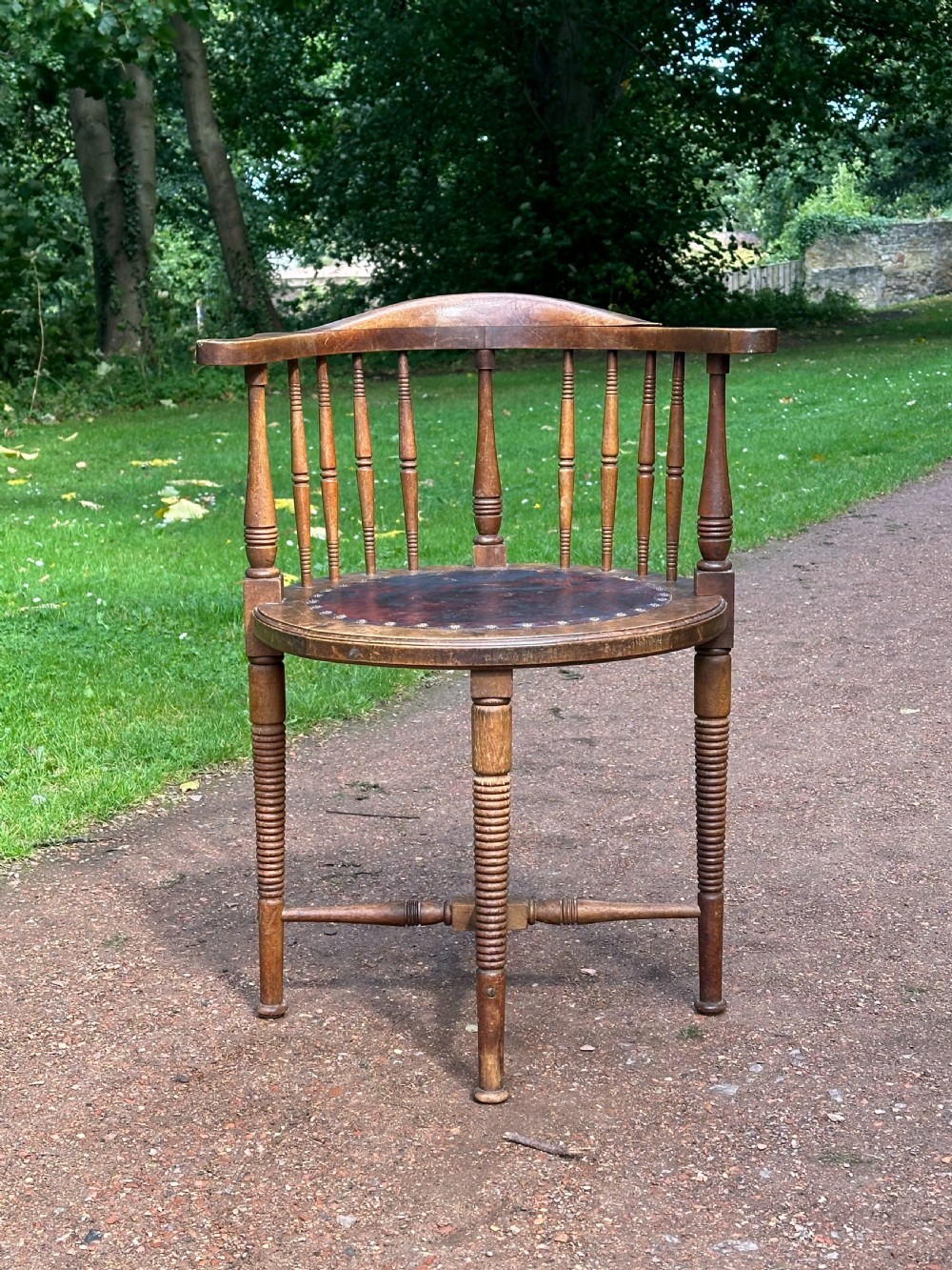 An Art Furniture walnut and leather upholstered chair, attributed to Liberty's / William Birch c.1900