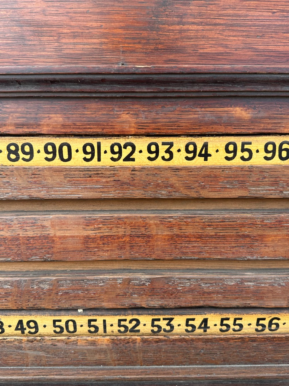 A nineteenth-century dark oak billiard scoreboard featuring numbered sliding brass pointers, moulded architectural cornices, and lower storage compartments. View II