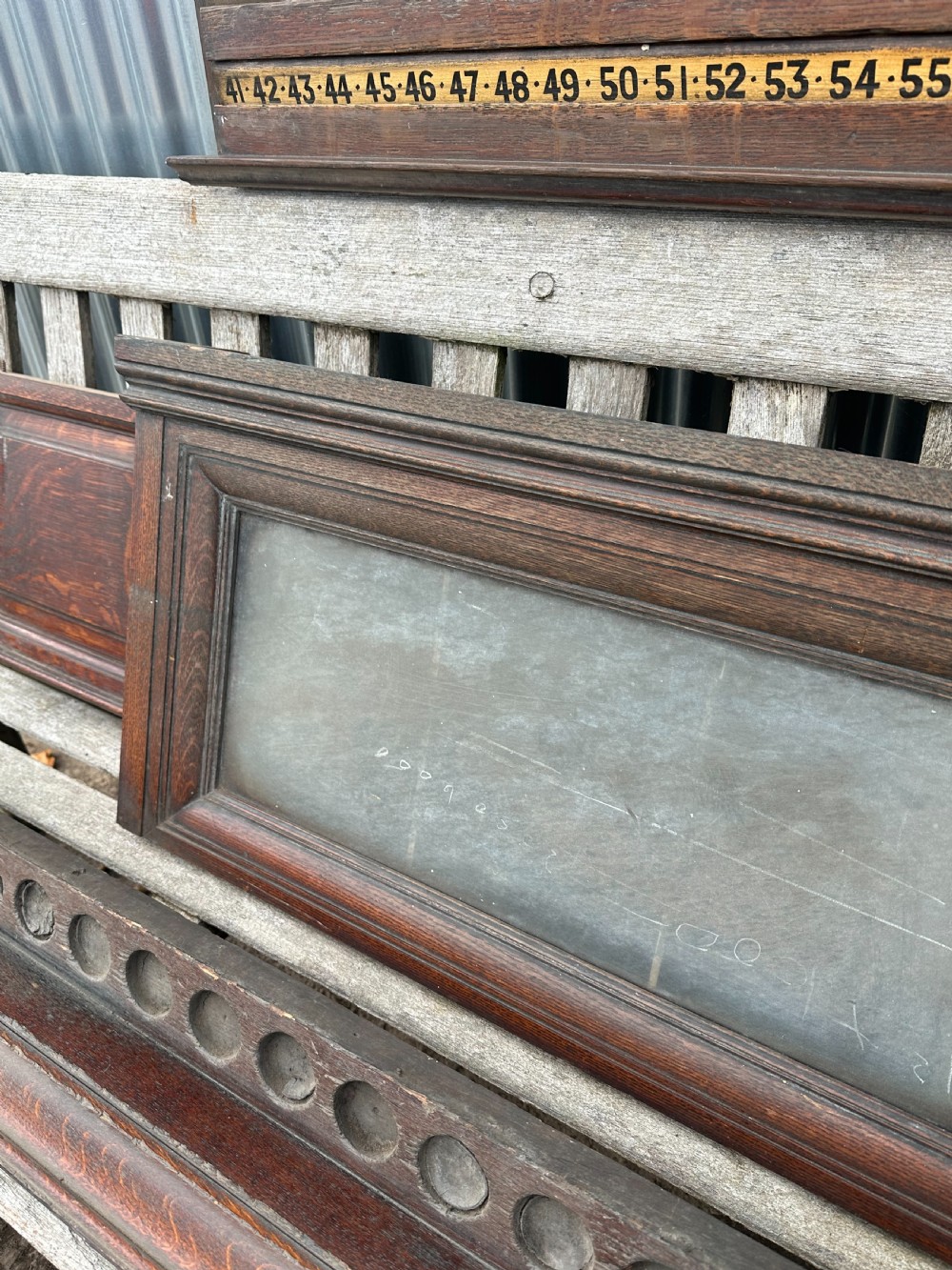 A nineteenth-century dark oak billiard scoreboard featuring numbered sliding brass pointers, moulded architectural cornices, and lower storage compartments. View VII