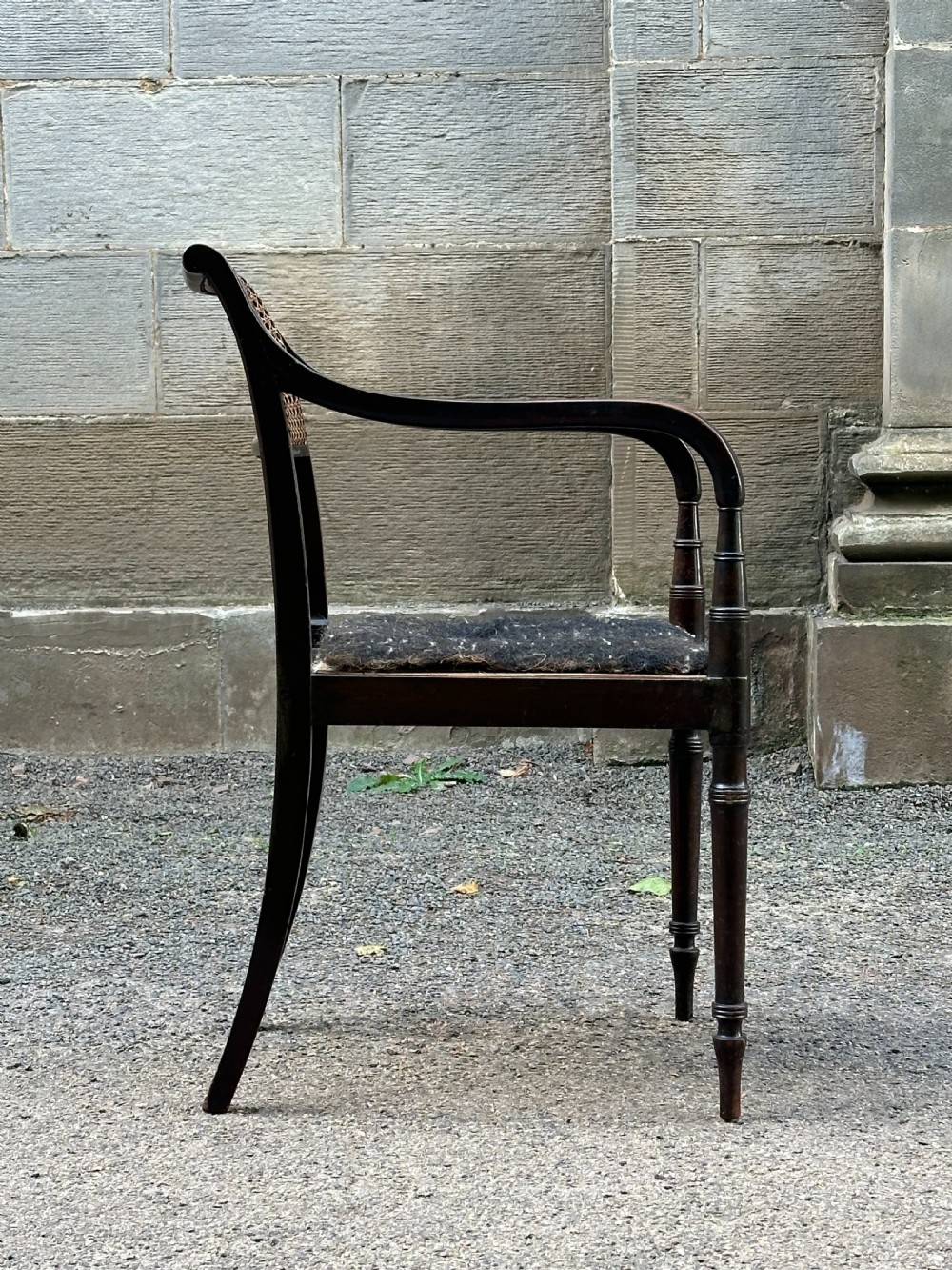 A Regency Grecian style japanned armchair attributed to Gillows, c.1810