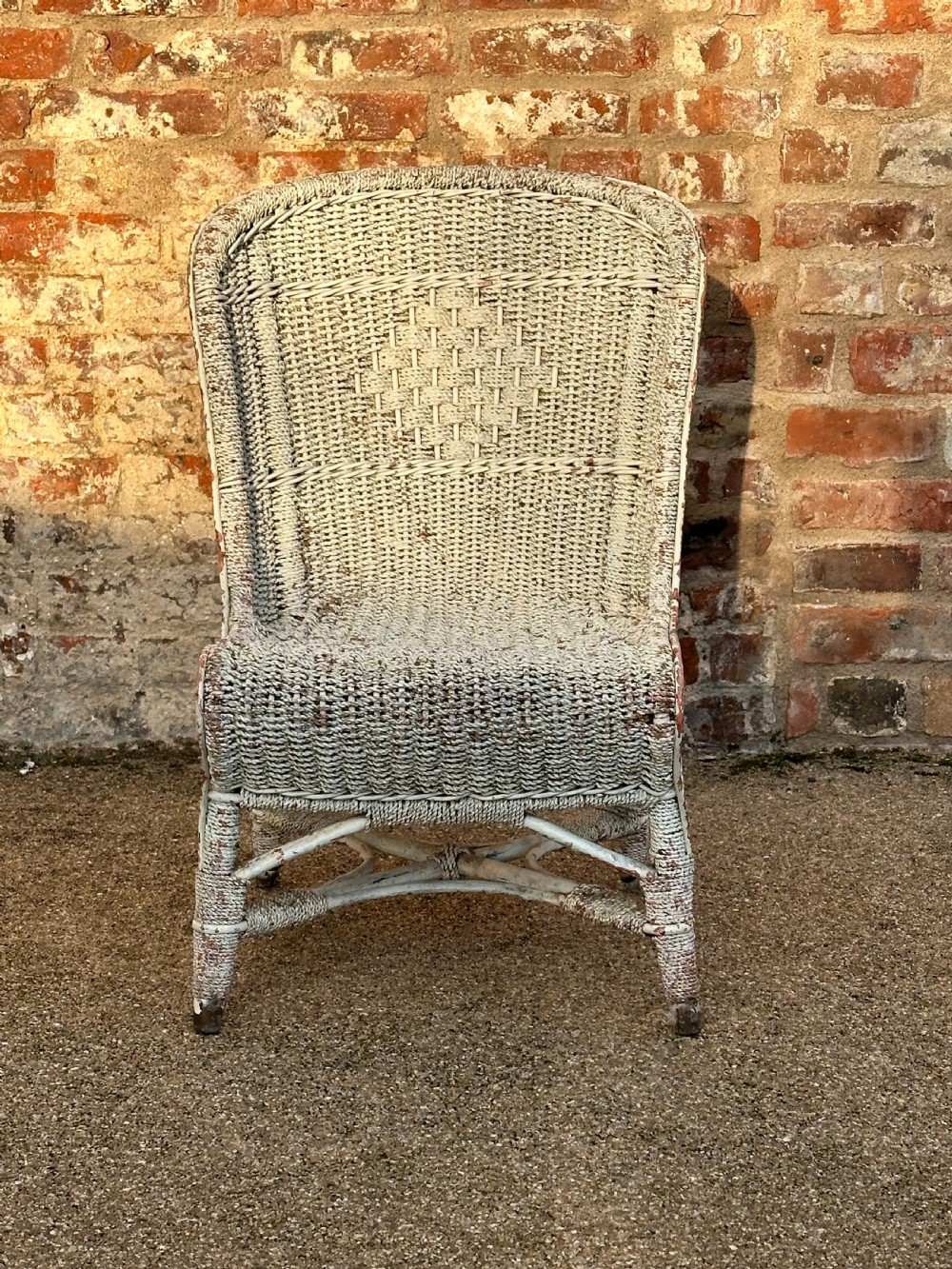 An unusual English cane and rope- work low chair, first quarter 20th century View II