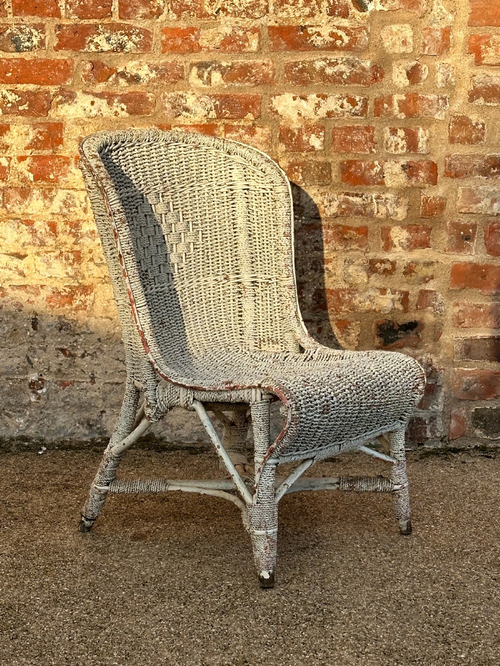 An unusual English cane and rope- work low chair, first quarter 20th century View III