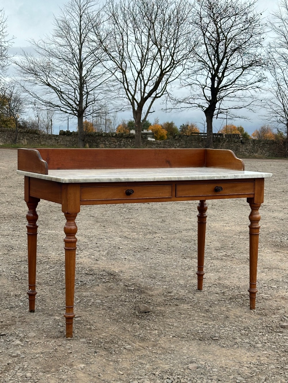  A George IV birch and  carrara marble washstand, 1820's