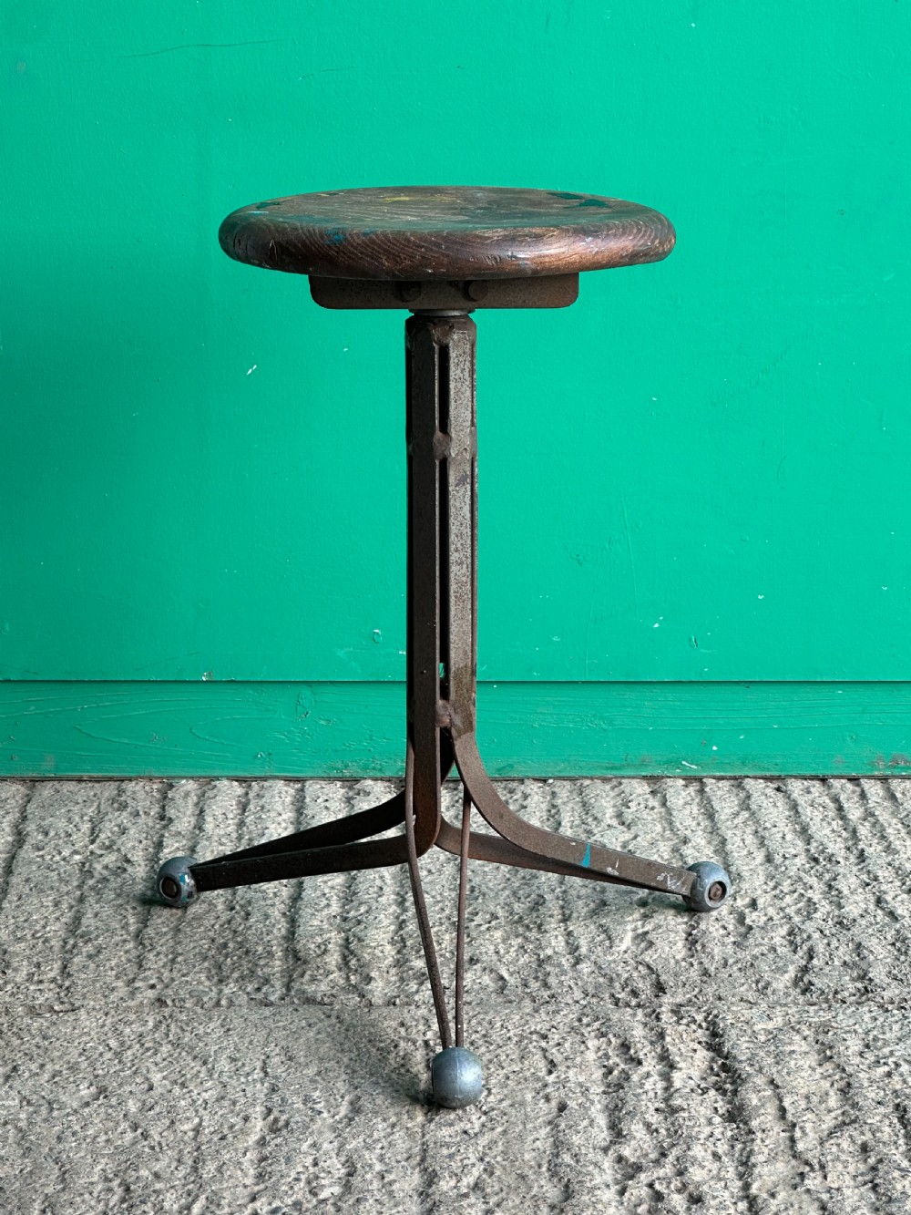 An English industrial metal stool with revolving elm seat, early 20th century