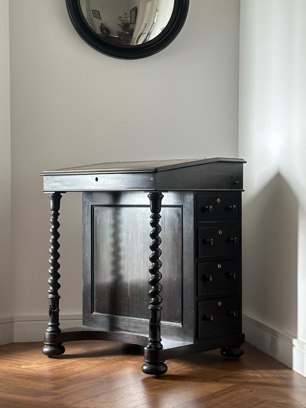 A fine English Regency ebony and satinwood-lined Davenport Desk
