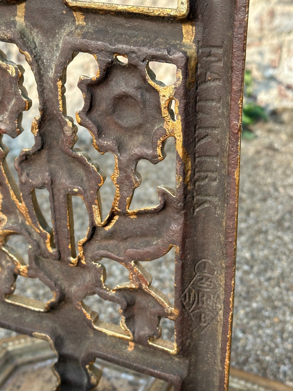 A gold-painted cast iron stick stand featuring a starburst arched cresting, stylised floral central panel, rectangular top ring, and a heavy drip tray base. View IV