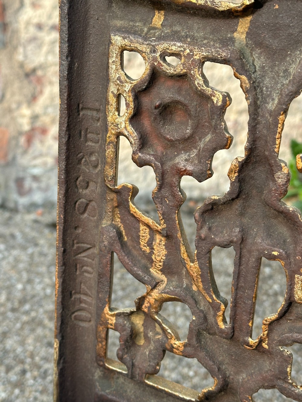 A gold-painted cast iron stick stand featuring a starburst arched cresting, stylised floral central panel, rectangular top ring, and a heavy drip tray base. View V