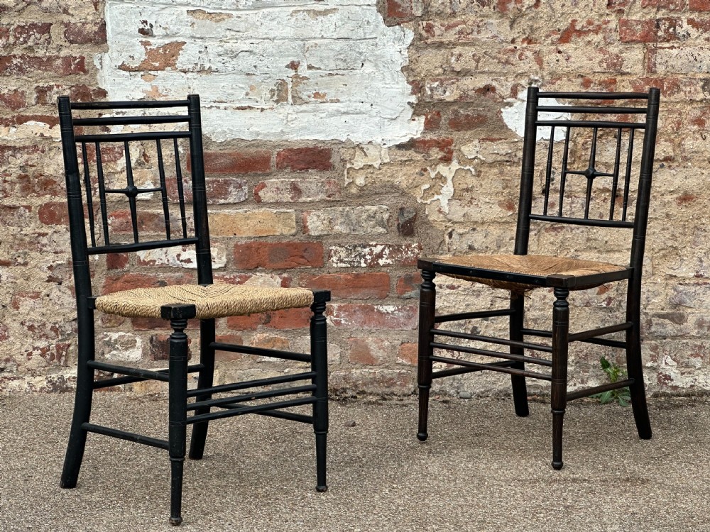 Two Ford Maddox Brown type Sussex chairs by Morris & Co.