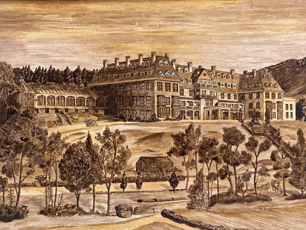 A sepia-toned wooden marquetry panel illustrating the architectural facade of Peebles Hydro surrounded by trees and grounds.