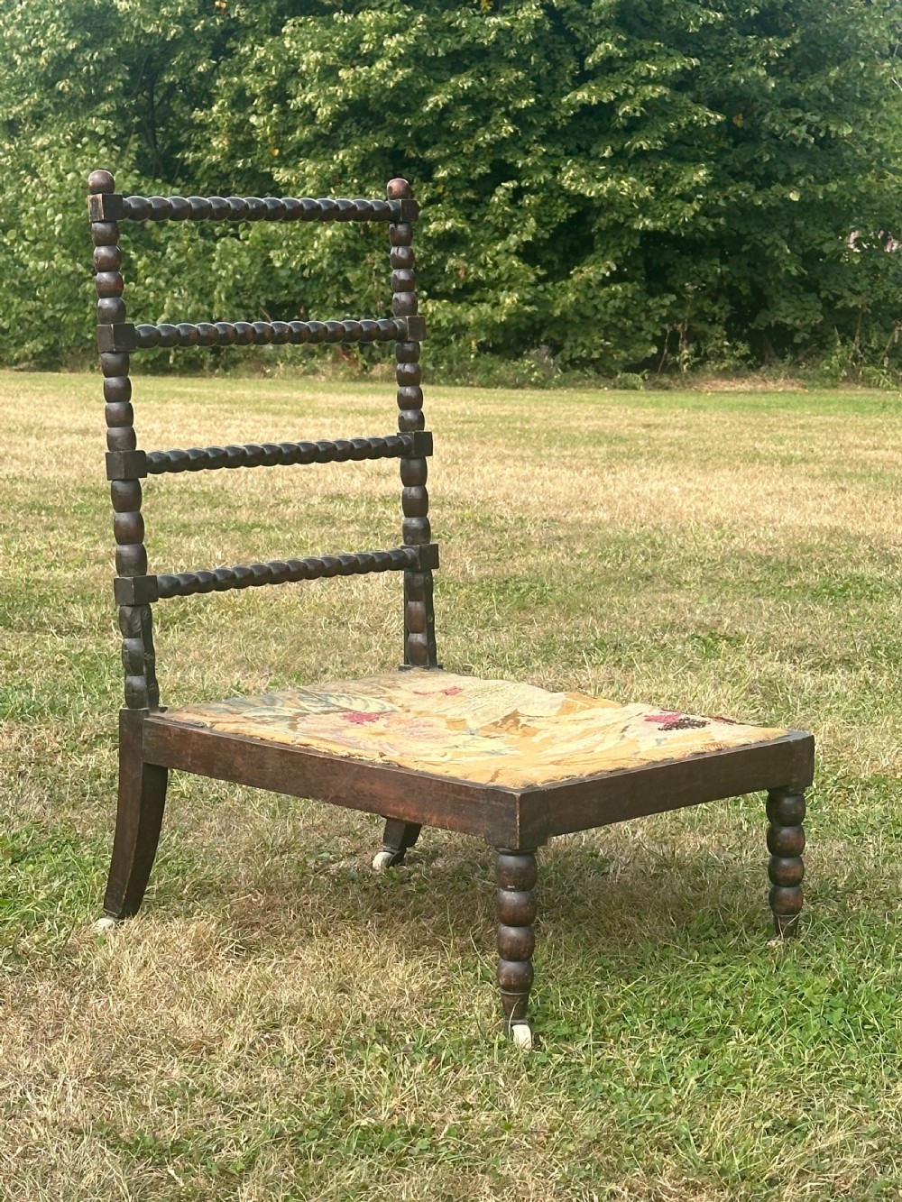 A 19th century ebonised bobbin chair, probably Scottish