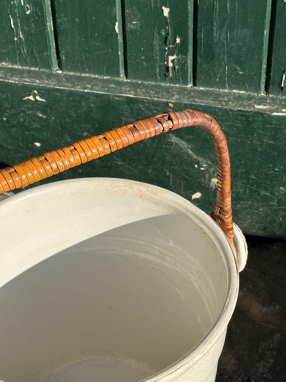 A cream-glazed ceramic bucket featuring a horizontal gilt line and a cane-wrapped overhead swing handle. View III
