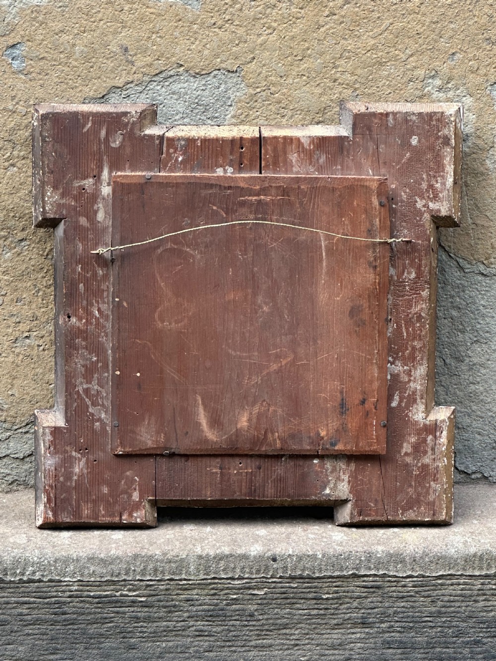A late 19th-century square dark wood wall mirror featuring stepped architectural outer corners and a central gilt-trimmed circular convex mirror. View V