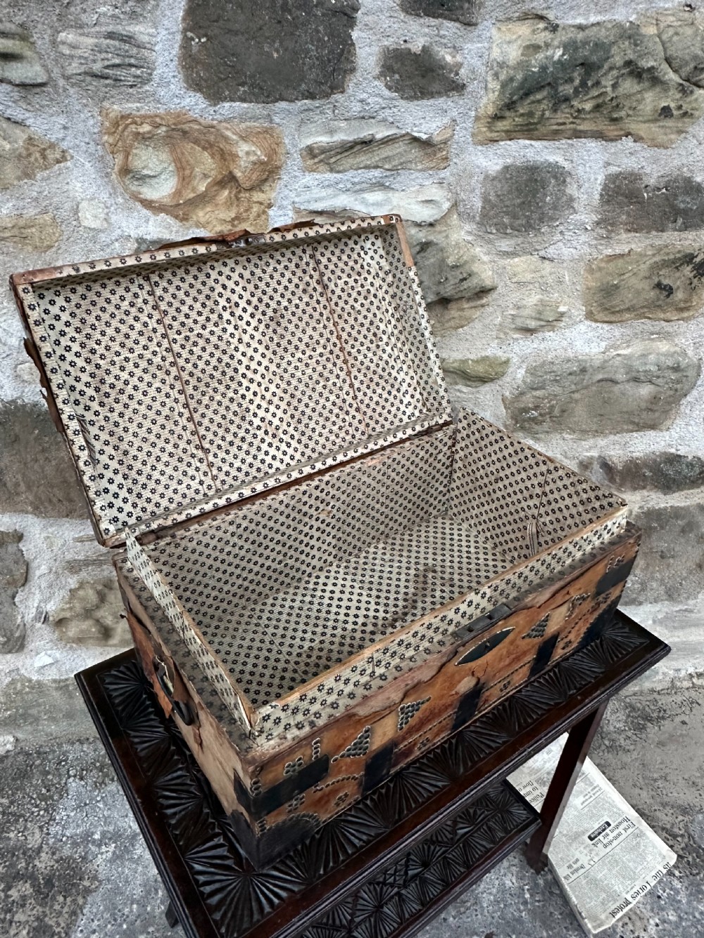 A late George III hide and metal bound travelling trunk featuring brass stud embellishments, iron corner brackets, and carrying handles. View VII