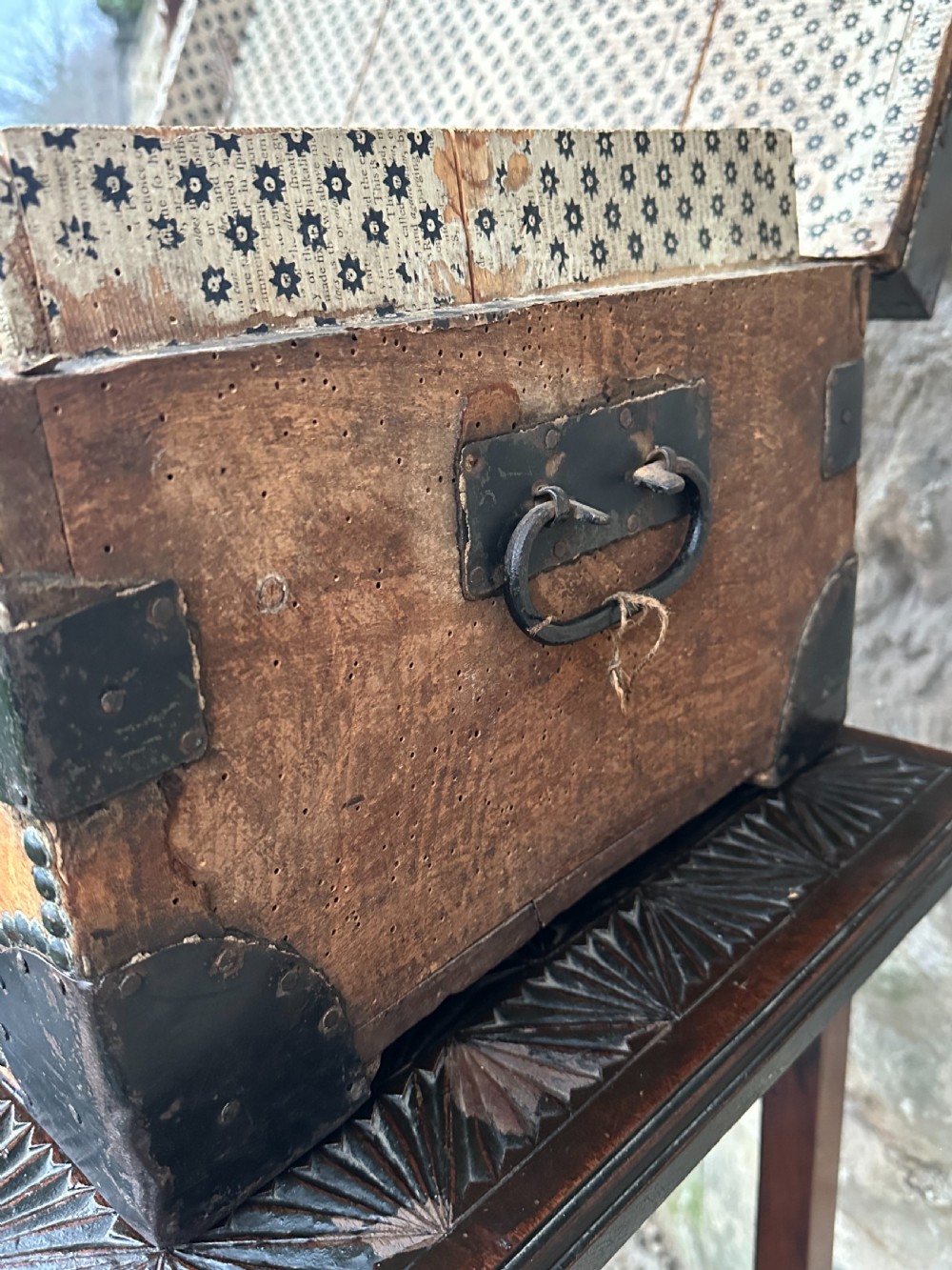 A late George III hide and metal bound travelling trunk featuring brass stud embellishments, iron corner brackets, and carrying handles. View IX