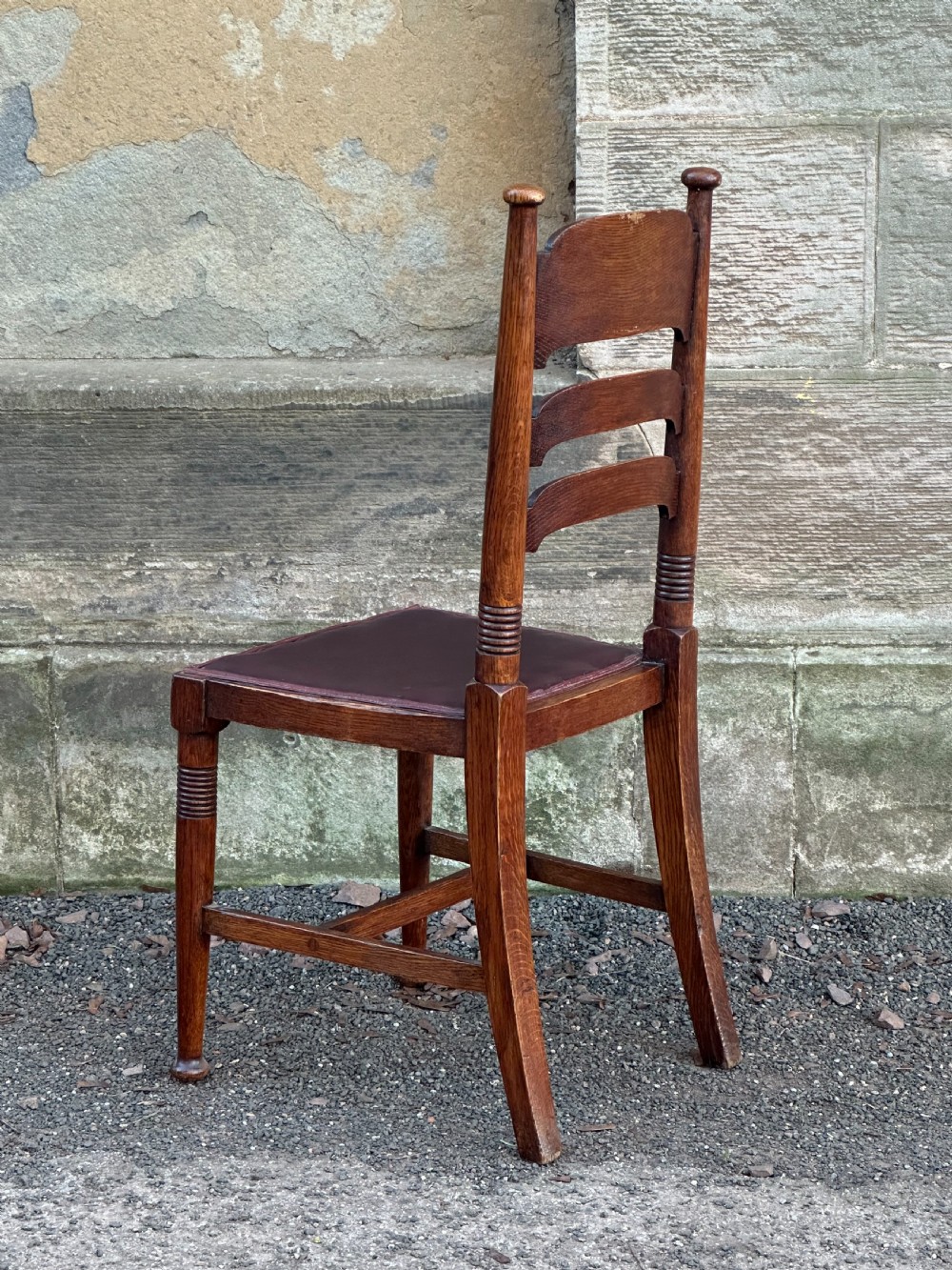 A pair of English Arts and Crafts oak side chairs by William Birch Ltd. c.1900 View II