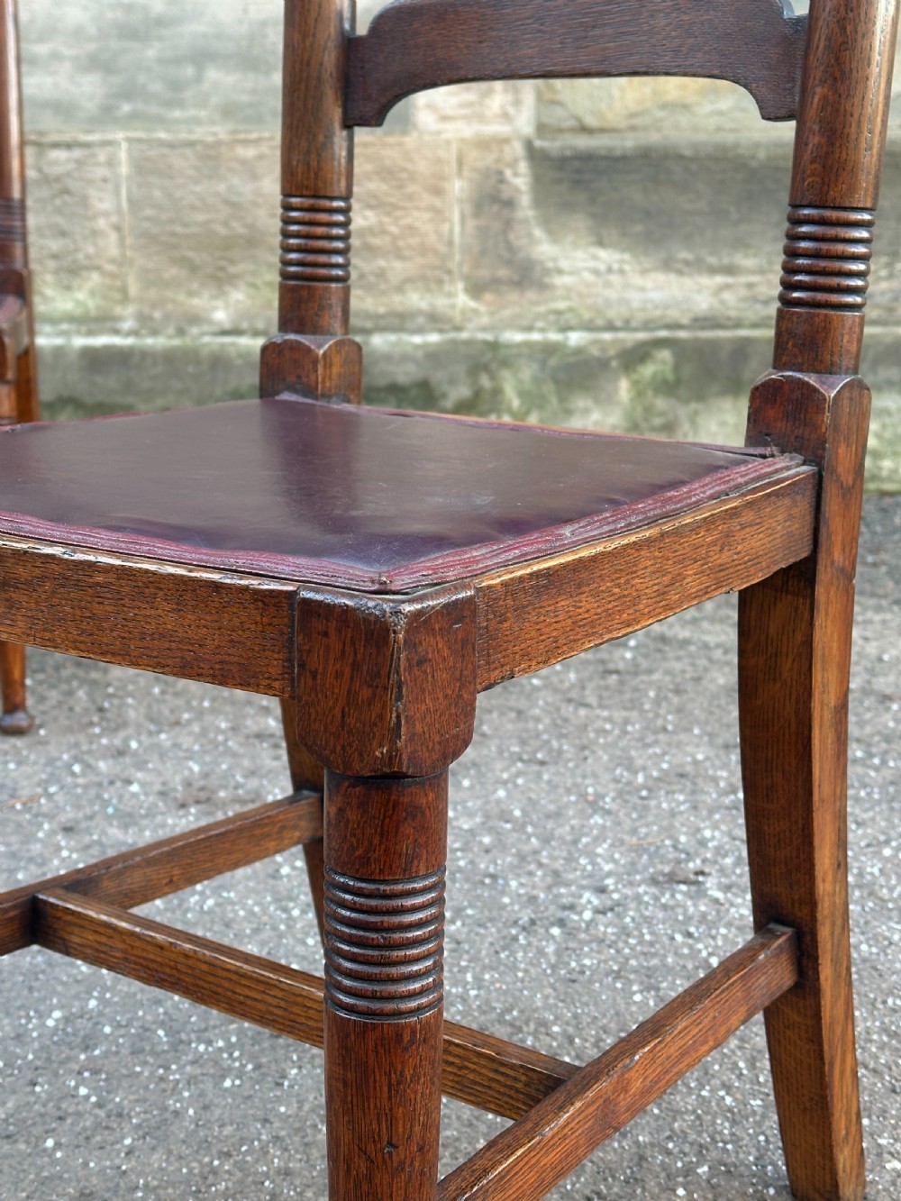 A pair of English Arts and Crafts oak side chairs by William Birch Ltd. c.1900 View III