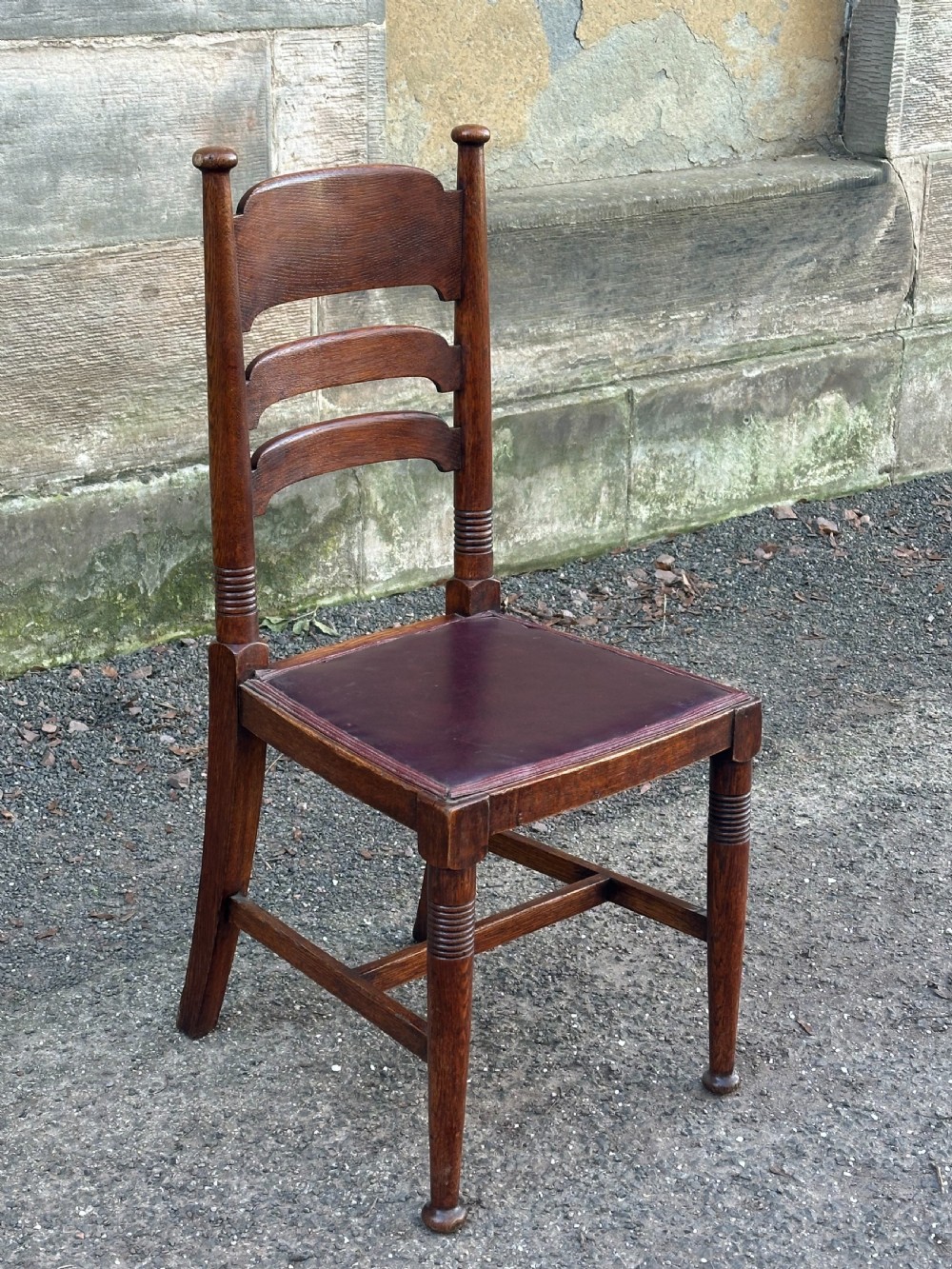 A pair of English Arts and Crafts oak side chairs by William Birch Ltd. c.1900 View IV